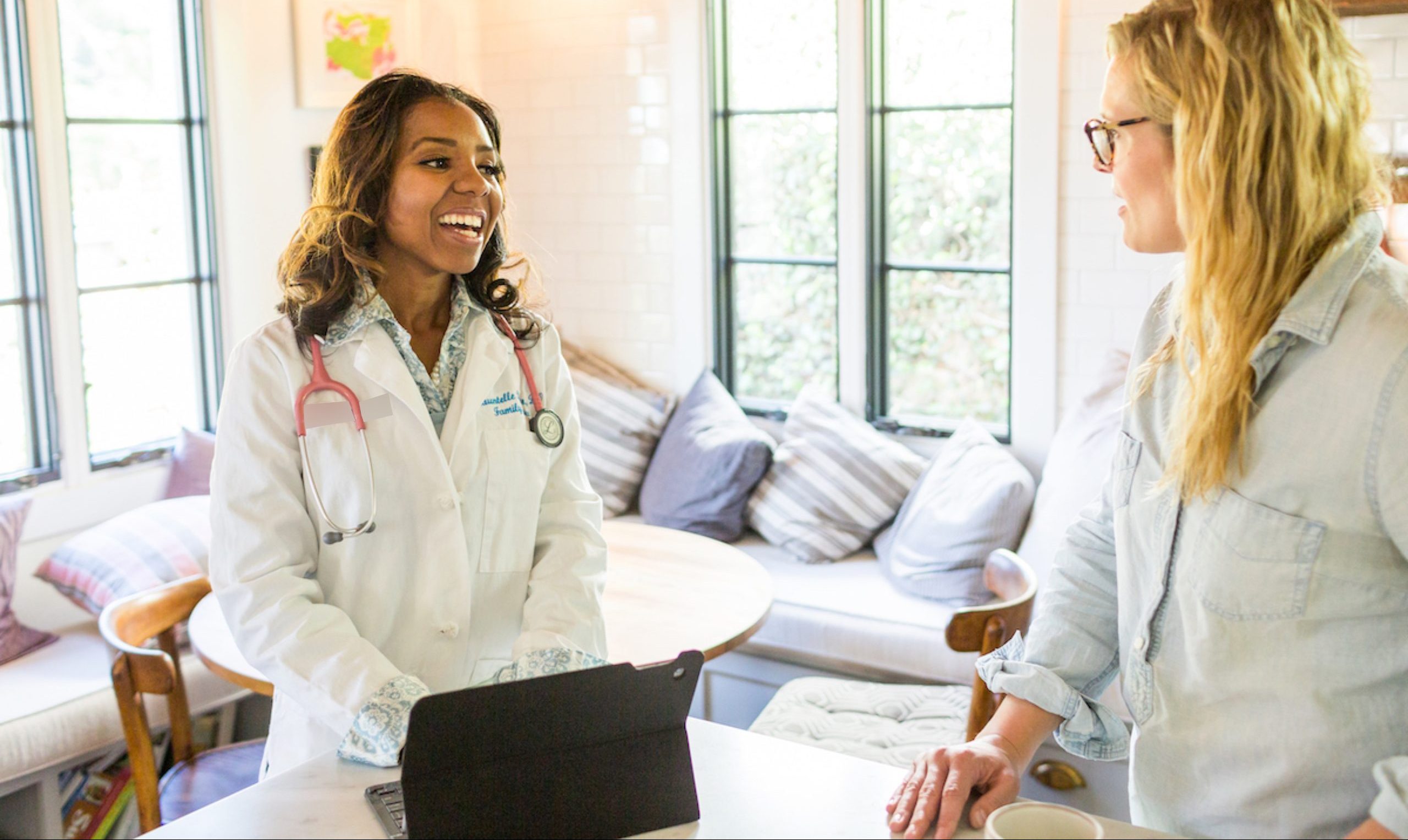 Portrait of Dr. Shauntelle Bonman Senkungu with a patient